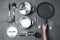 Woman holding frying pan over table with clean cookware