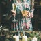 Woman holding glass of champaigne and gift box, square crop