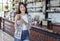 Woman holding glass of iced chocolate milk in a cafe