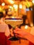 Woman holding glass with margarita cocktail on blurred background