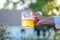 woman holding a glass mug of beer in summer