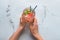 Woman holding glass of tasty cold watermelon lemonade on light table