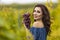 Woman Holding Grapes In Her Hand In Vineyard.Autumn Season
