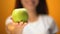 Woman holding green apple, concept of slimming and healthy diet, vitamin closeup