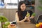 Woman holding a green apple and a green pepper, cooking blogger