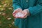 Woman holding hail grains after thunderstorm outdoors, closeup