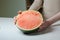 Woman holding halves of watermelon