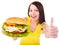 Woman holding hamburger.