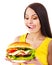 Woman holding hamburger.