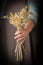 Woman holding in hand ears of oats, closeup.