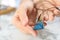 Woman holding handmade gemstone amulet at table