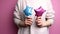 Woman holding in hands pink and blue inflatable star foil balloons.