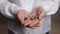 Woman holding a hearing aid. Hands Of Woman Holding A Hearing Aid. Closeup. Employee of a medical clinic shows a hearing