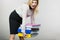 Woman holding heavy colorful binders with documents