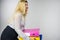 Woman holding heavy colorful binders with documents