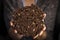 Woman holding in her hands a home made black bread from chocolate and nuts