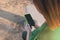 Woman holding her smartphone with a green case. Copy space. Focus selected