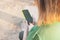 Woman holding her smartphone with a green case. Copy space. Focus selected