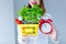 Woman holding herbs of basil and red tomatoes in market basket