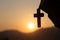 Woman holding a holy bible and cross in her hands and praying in the morning. Hands folded in prayer on a Holy Bible in church