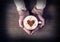 Woman holding hot cup of coffee, with heart shape