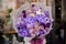 Woman holding a huge bouquet of tender violet color flowers