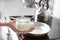 Woman holding jar with coconut oil near kitchen