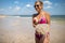 Woman holding jellyfish while standing on the coast