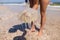 Woman holding jellyfish while standing on the coast