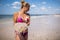 Woman holding jellyfish while standing on the coast