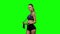 Woman holding jump rope on her shoulders. Green screen