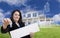 Woman Holding Keys, Blank Sign with Ghosted House Drawing Behind