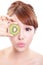 Woman holding kiwi fruit cover her eyes