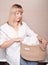 woman holding a knit jute basket with fresh towels in bathroom. housekeeping and householding using natural storage