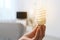 Woman holding lamp bulb in living room.