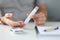 Woman holding lancet near her finger to measure blood glucose closeup