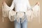 Woman holding large macrame on beige background, closeup