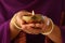 Woman holding lit diya lamp in hands, closeup. Diwali celebration