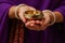 Woman holding lit diya lamp in hands, closeup. Diwali celebration