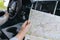 Woman holding map in car on road trip