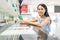 Woman holding mobile phone in check in counter at airport