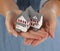 Woman Holding Model Home in Hands