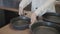 Woman holding modern frying pan. Action. Close-up of woman advertising new frying pans. Woman removes handle from frying