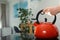 Woman holding modern kettle on stove in kitchen, closeup