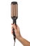 Woman holding modern triple curling iron on white, closeup