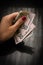 Woman holding money, counting dollars close up