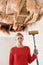 Woman Holding Mop Under Damaged Ceiling