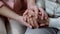 Woman holding mother hands closeup, nursing home support, family love and help