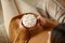 woman holding mug of marshmallow and whipped cream