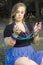 A woman holding multicolored mardi gras beads